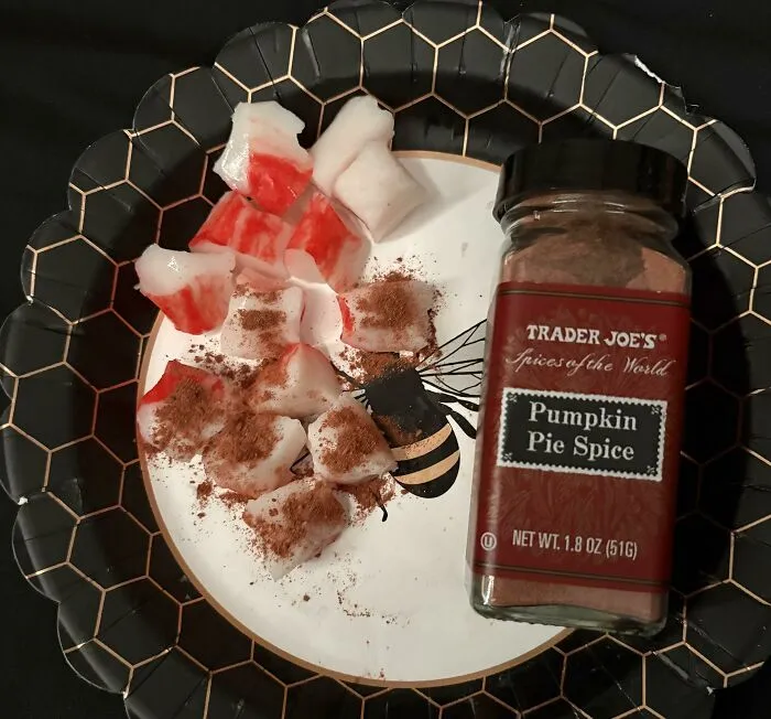 Imitation crab meat pieces sprinkled with pumpkin pie spice, illustrating strange food combinations.