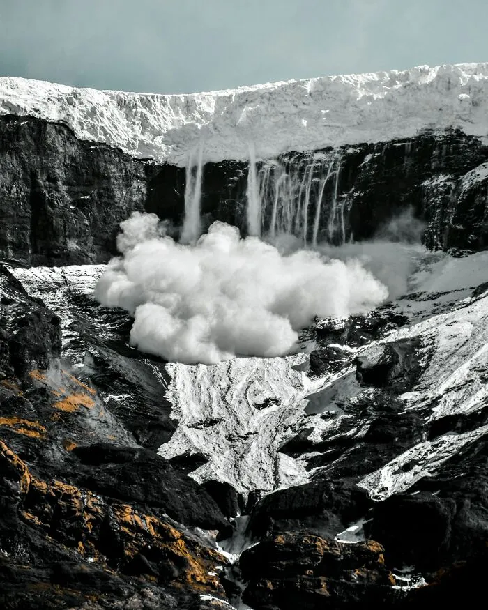 A massive avalanche of snow sliding down a steep mountain, highlighting facts for winter emergencies