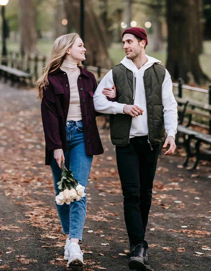 A happy couple walking together outdoors, demonstrating respectful ways how men should treat women.