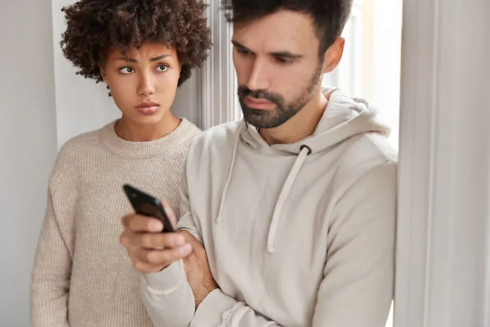 Couple arguing as man ignores woman showing toxic relationship traits