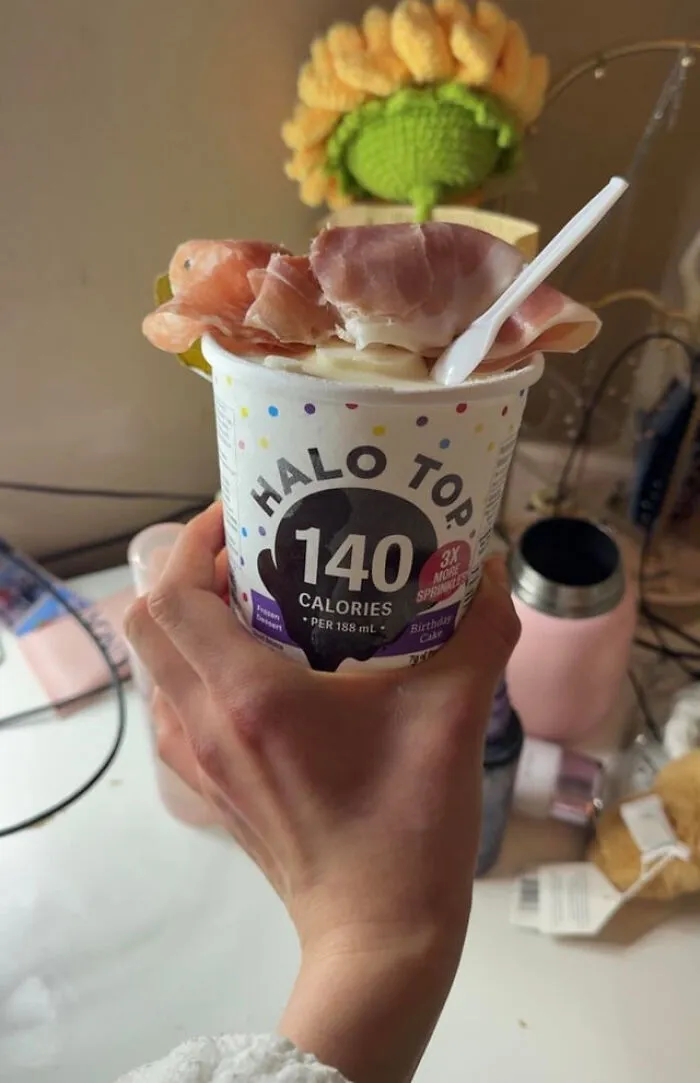 Strange food combinations featuring a cup of ice cream topped with slices of prosciutto ham.