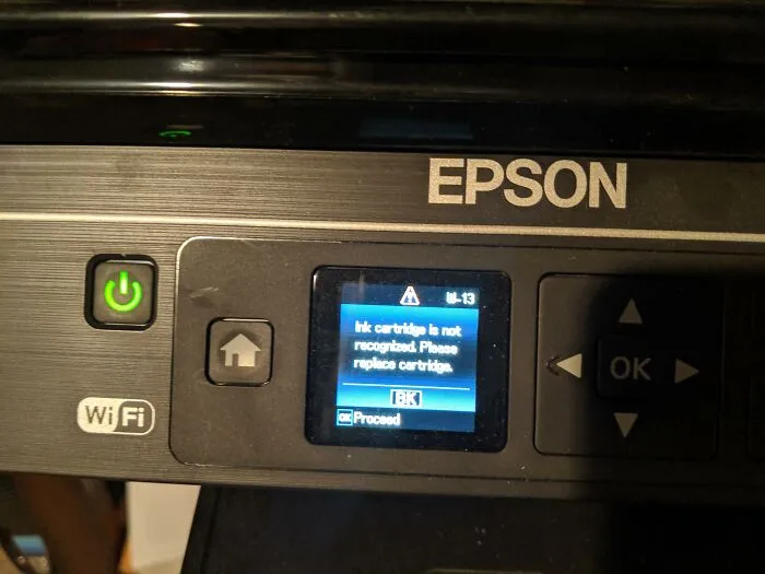 Epson printer screen showing an unrecognized ink cartridge error, a terrible product design