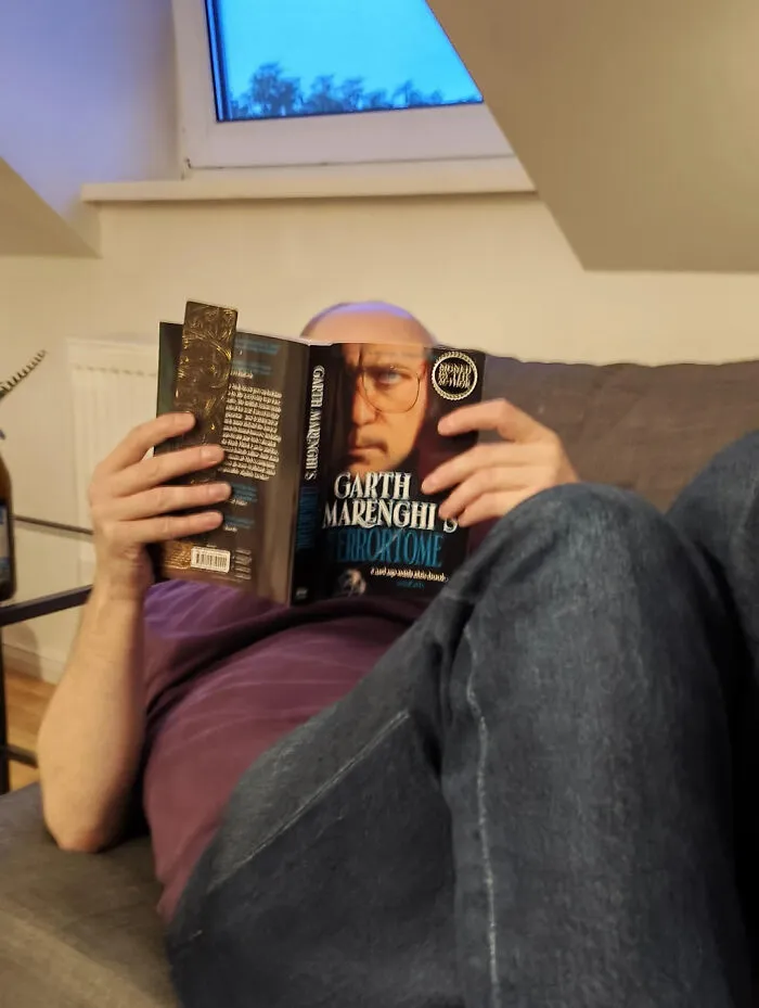 My Friend Reading His Book Has Had His Face Replaced By Garth Marenghi