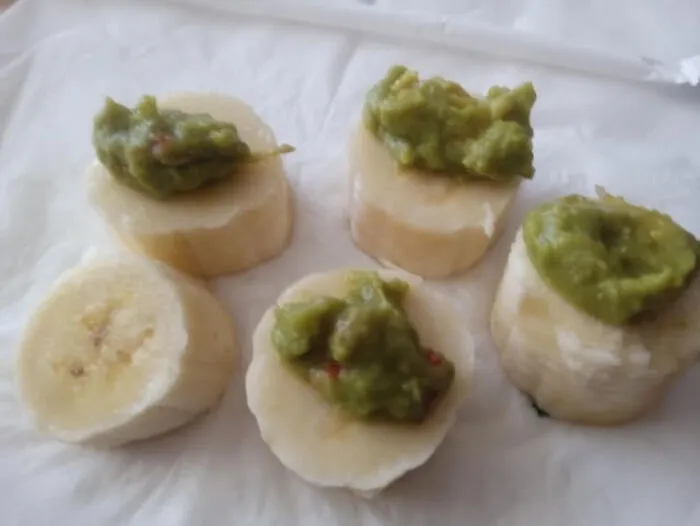Strange food combinations with sliced bananas topped with guacamole