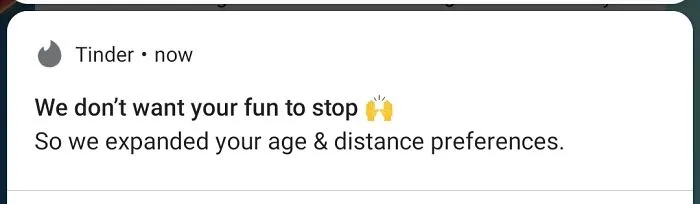 A Tinder notification stating they expanded user preferences without consent, demonstrating terrible product design.