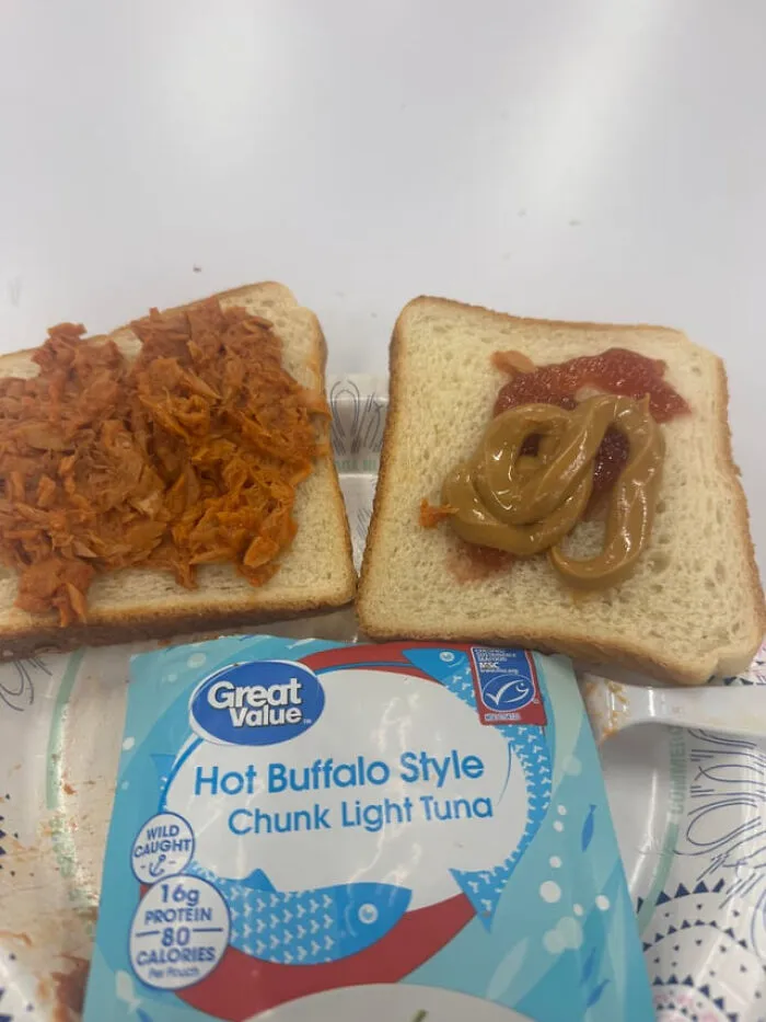 An open-faced sandwich with tuna on one slice and peanut butter on the other, creating weird food combinations.