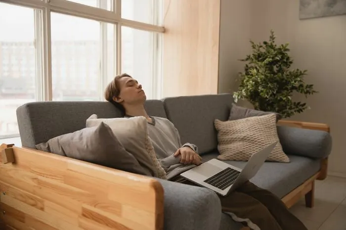 A young man resting on a sofa with eyes closed, useful facts in an emergency