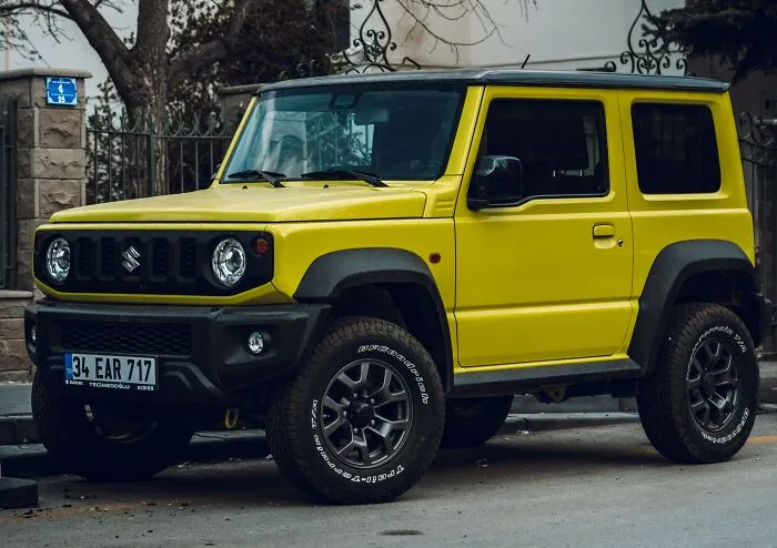 A bright yellow SUV parked on the street, showing a modern display of having money