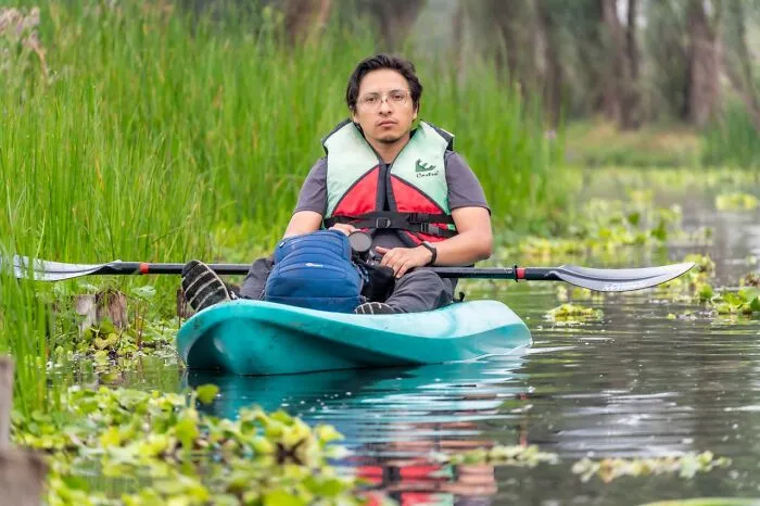 Man wearing a life jacket in a kayak on water, showcasing safety facts in a drowning emergency