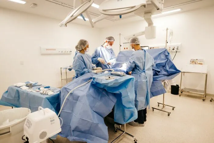A medical team performing surgery in an operating room, preparedness for a medical emergency.