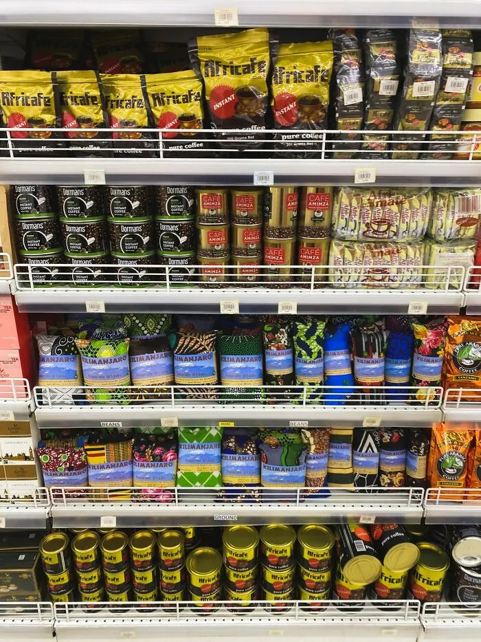 Supermarket shelves packed with various coffee brands, representing middle-class life choices