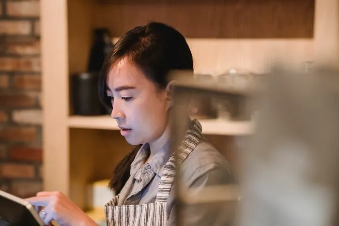 Barista using tablet in cozy restaurant setting