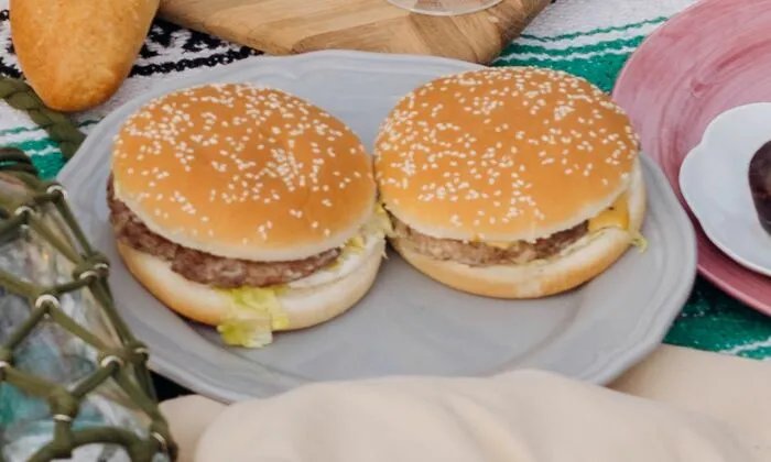 Two burgers served on a plate, representing quick dining options in middle-class life