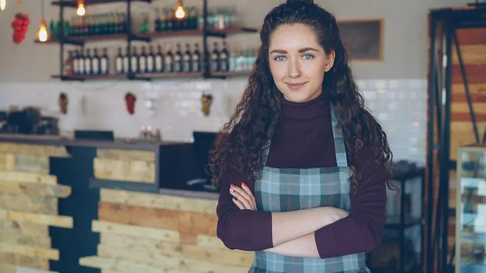 Confident restaurant owner standing with arms crossed