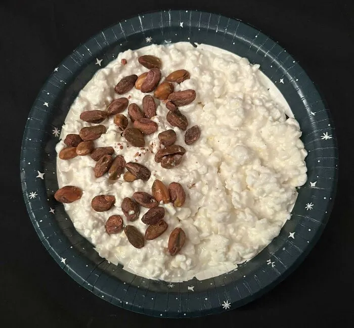 A bowl of cottage cheese topped with pistachios, showcasing unusual food combinations
