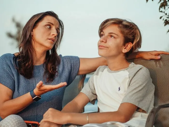 A mother talking seriously to her teenager, hinting at family challenges why marriages collapsed.