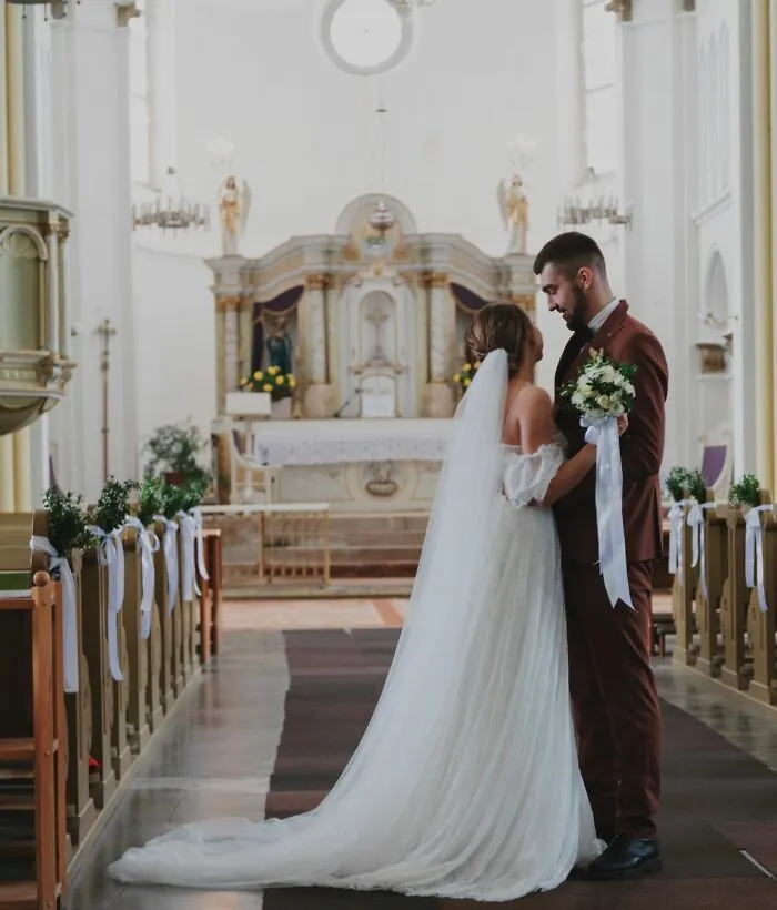 A bride and groom standing in a church, highlighting why love alone isn’t enough to keep them together.
