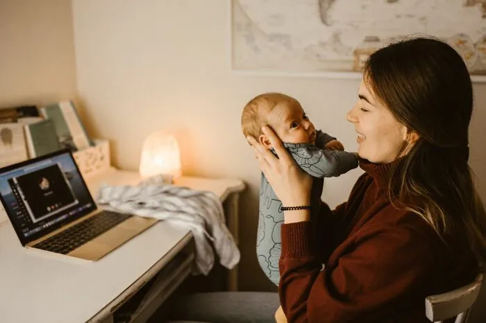 Working mother holding her baby to show reasons marriages collapsed