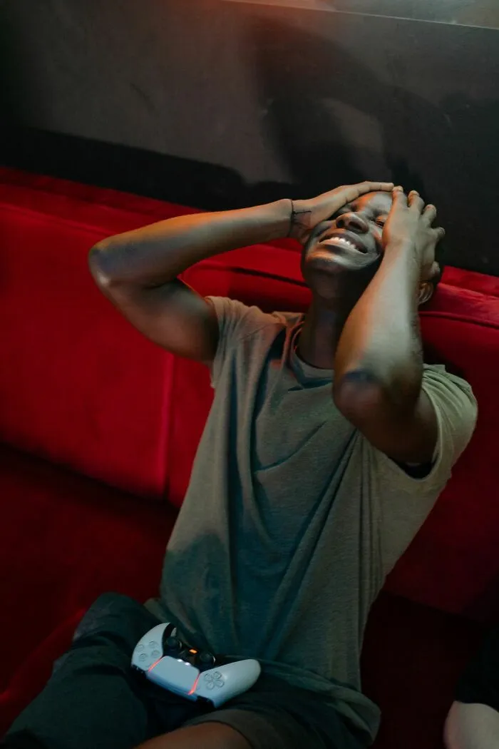 A laughing man holding his head, reading funny relationship revenge stories