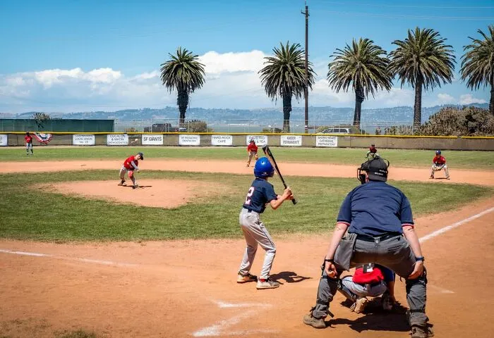 Youth baseball game in action, a distraction during relationship revenge stories.