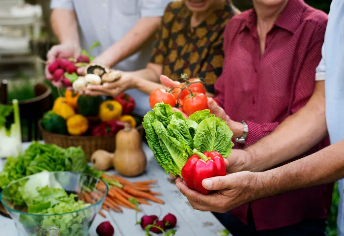 Group showing fresh vegetables including lettuce and red pepper