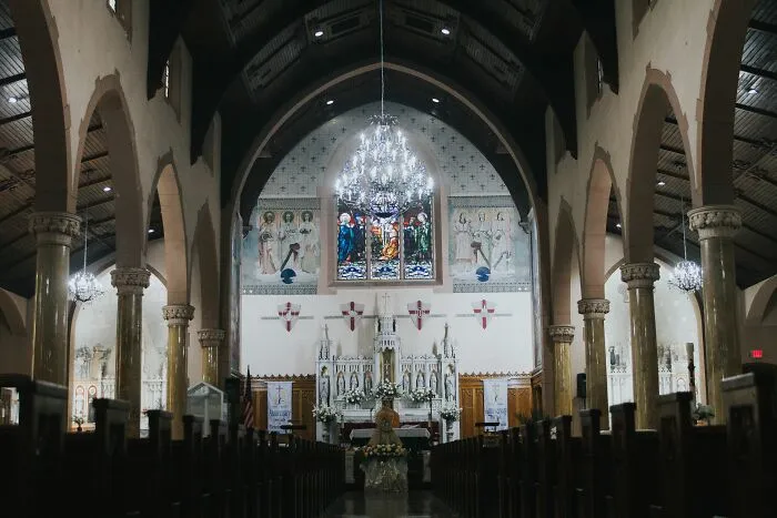 Interior of ornate church with stained glass highlighting secret history