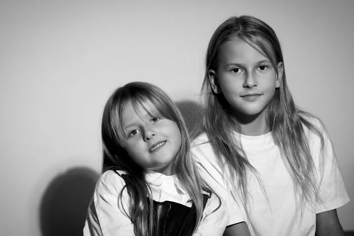 Black and white portrait of two girls symbolizing family secrets
