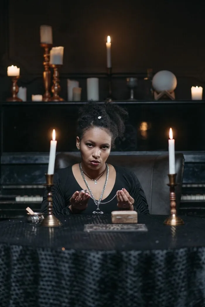 A service worker encounters a mystic woman in a dimly lit room, sharing one of the weirdest things they've walked into.
