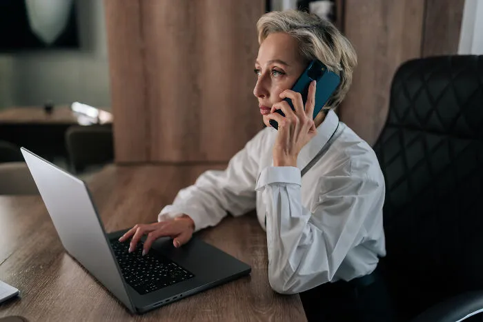 A female employee works on a laptop, reminding us of subtle sexism in the workplace.