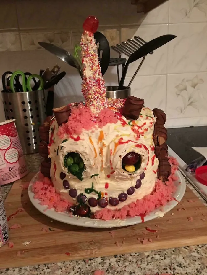 A decorated monster cake with candy eyes and sprinkles representing a funny baking fail.