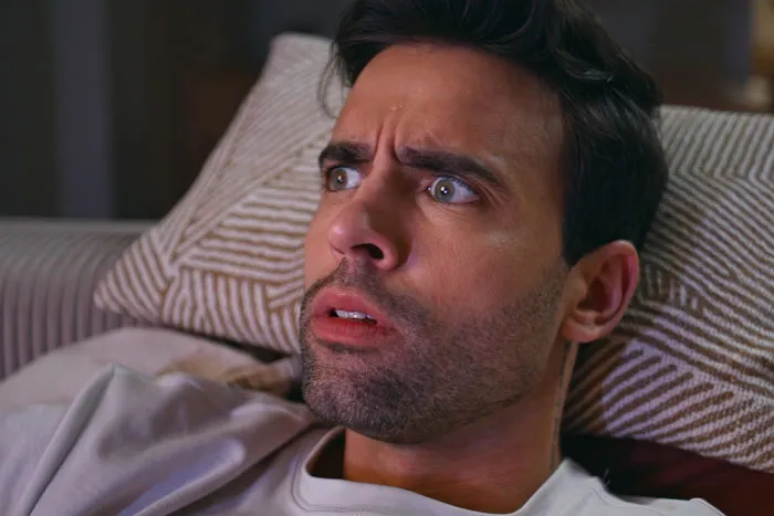 A terrified man staring wide-eyed in fear, evoking scary Halloween stories.