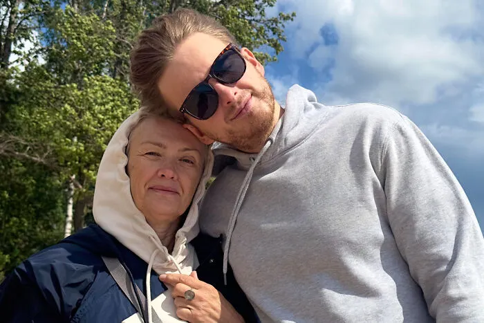 A mother and her adult son, showing a classic example of helicopter parenting dynamics.