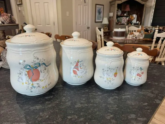 Set of four vintage ceramic canisters with fruit and animal designs from thrift store