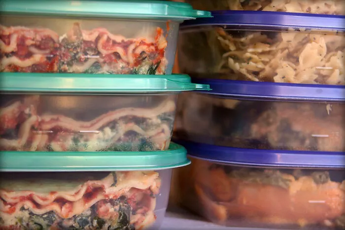 Stacked containers with lasagna and pasta for practical life hacks meal prep