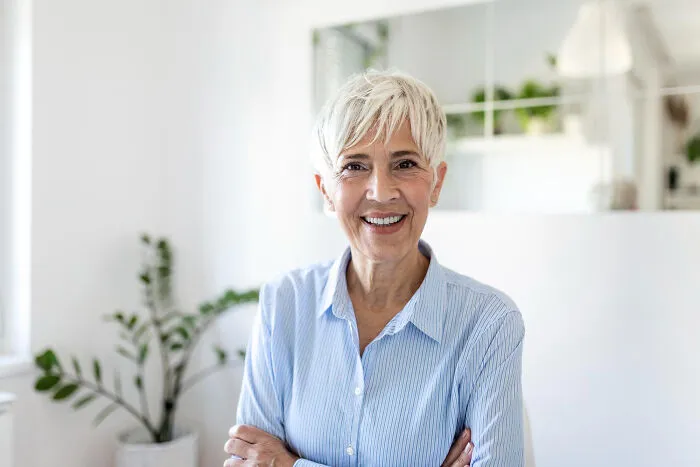 A smiling mature woman who decided to skip a second date looking at the camera