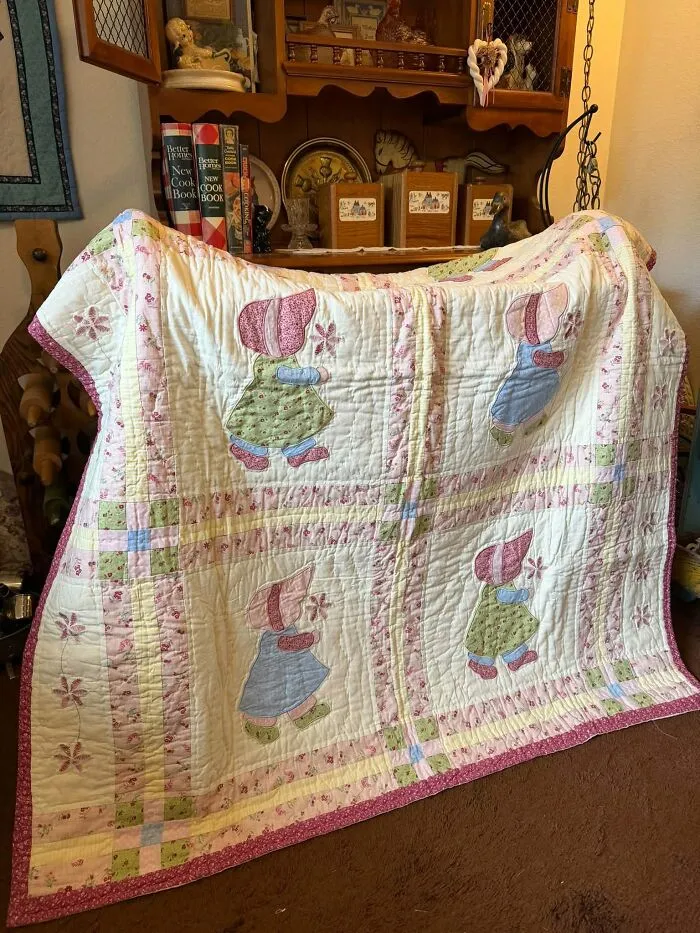 Vintage thrift store quilt with patchwork and floral Sunbonnet Sue designs