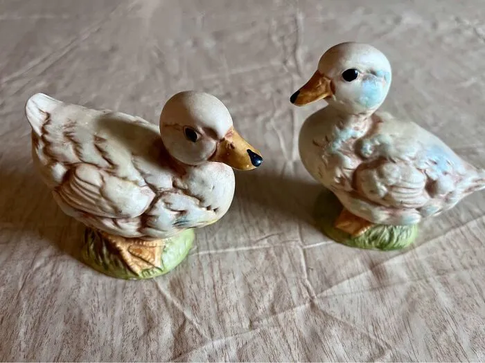 Ceramic duck figurines found at a thrift store on a textured surface