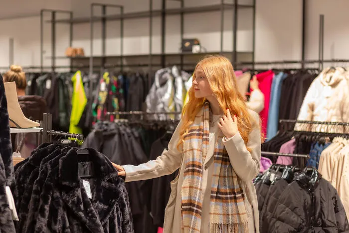 Woman shopping for winter coats in a clothing store