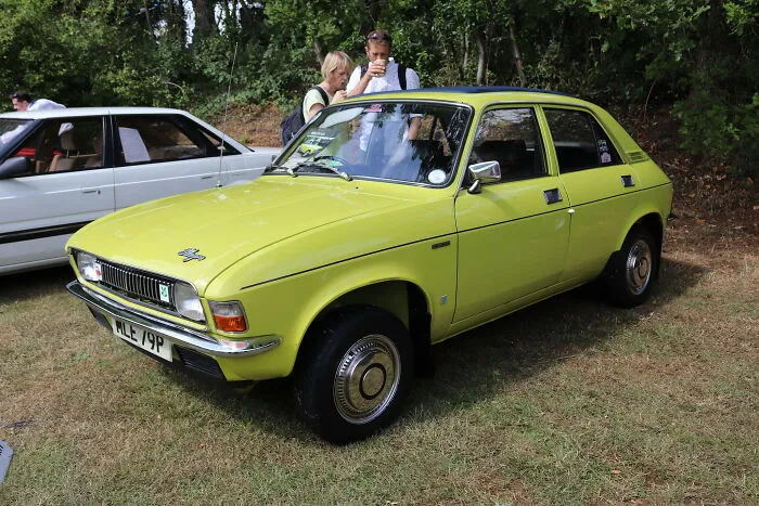 A classic yellow car parked outdoors symbolizing unexpected occurrences at funerals.