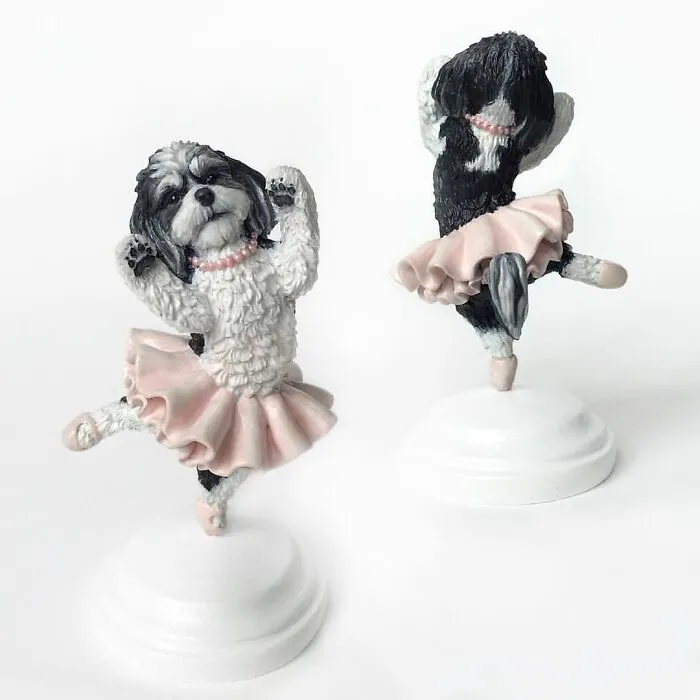 Front and back views of hyperrealistic pet sculptures of black and white dogs in pink ballerina tutus