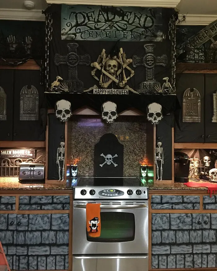Kitchen decorated with skulls and gravestones for Halloween homes inspiration.