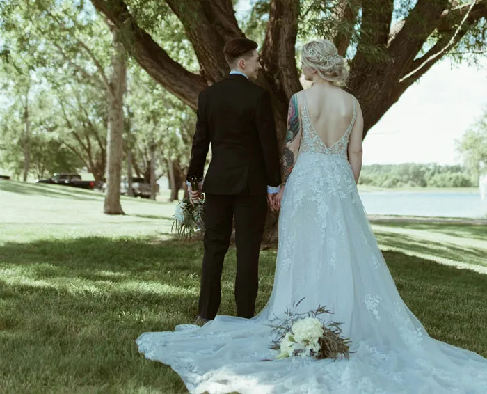 Newlywed couple standing together outdoors, taking a break from bridezilla stories