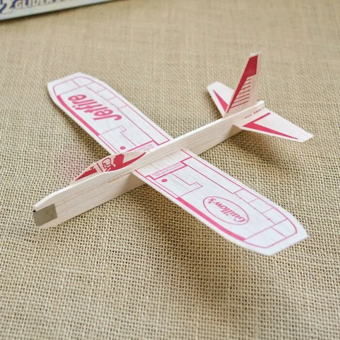 A vintage balsa wood toy glider plane bringing nostalgic memories for 80s kids.