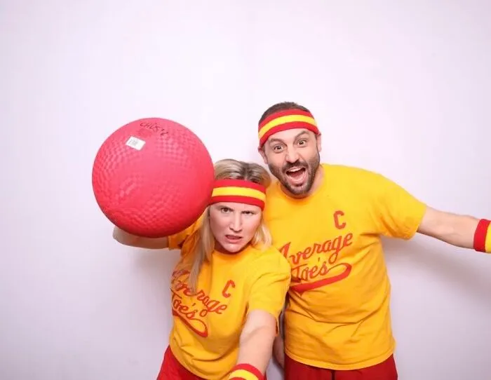 A couple dressed in yellow Average Joes dodgeball uniforms for a low-effort Halloween costume.