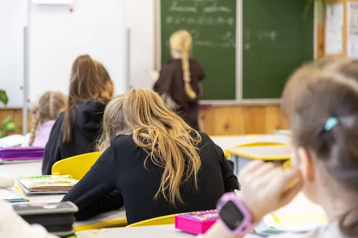 Students sitting in a classroom, feeling bored and ignored by infuriating teachers.