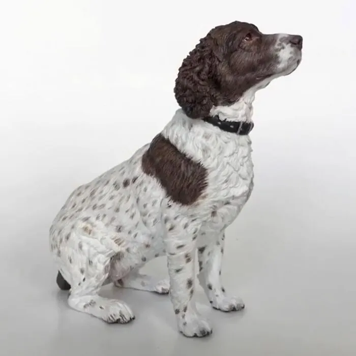 A detailed, hyperrealistic sculpture of a spotted hunting dog sitting patiently.