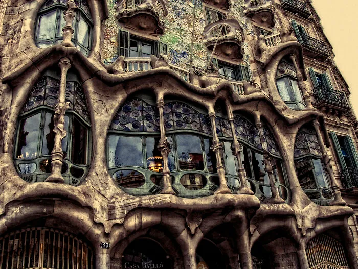 Detailed facade of Casa Batllo in Barcelona showing bizarre shapes of architecture.