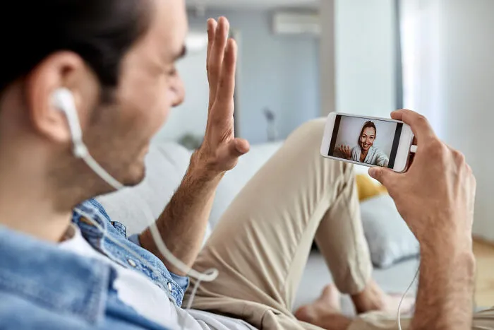 Man on a video call showing an example of helicopter parenting behavior