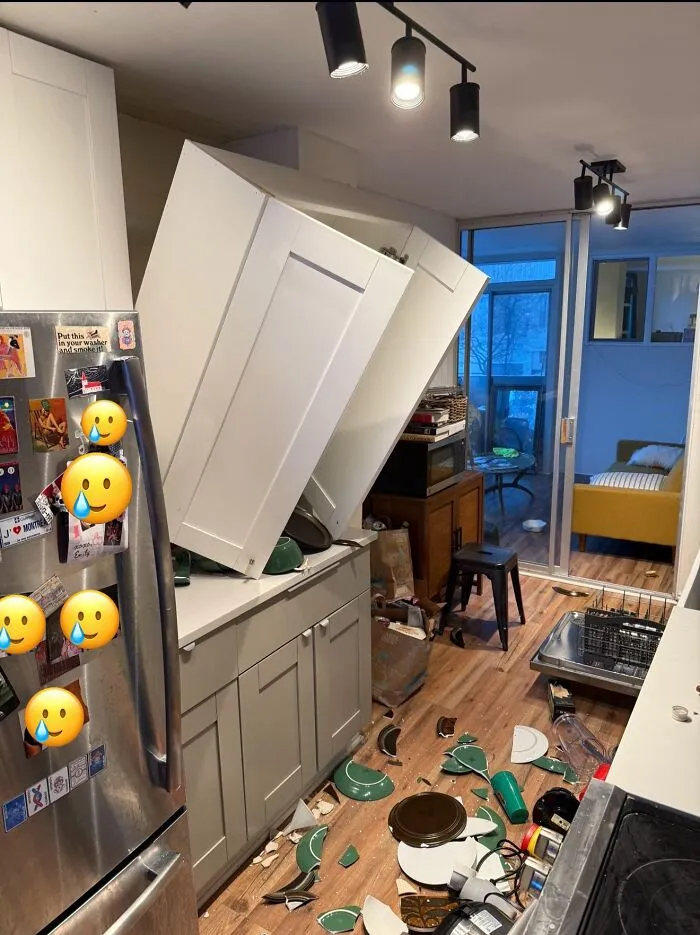 Absurd moment where kitchen cabinets completely fell off the wall and smashed dishes on the floor.