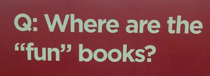 Red wall sign asking Where are the fun books with misused quotation marks.